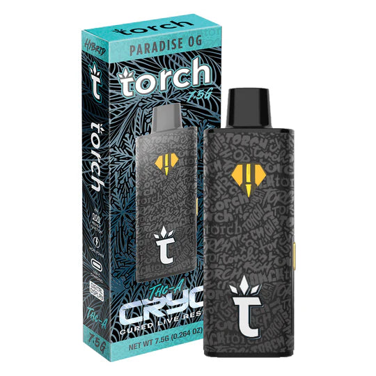 A black Torch vape pen with a graffiti-style design is displayed next to its colorful box, labeled "Paradise OG" and "7.56g (0.264 oz)." The disposable vape features a leafy background, various product details, and showcases the potent Torch CRYO THCA Live Resin Disposable | 7.5g by Torch.