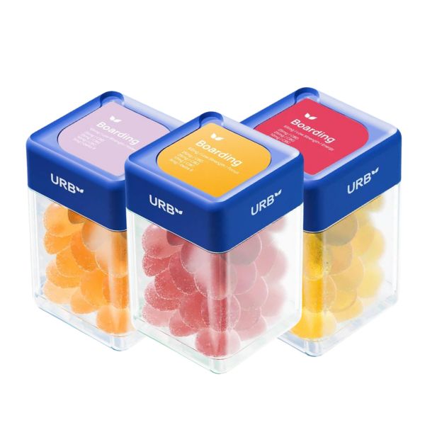 Three clear square containers with blue lids labeled "Urb" contain differently colored gummy supplements: orange, pink, and yellow. Each lid is also labeled with the word "Boarding." These are Urb Boarding Skybites Delta 9 Gummies, perfect for those seeking Delta 9 THC or CBD gummies.