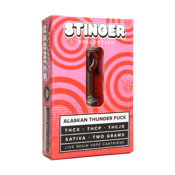 A red and pink box labeled "Honeyroot Stinger Collection" containing a live resin vape cartridge named "Alaskan Thunder Fuck" with US-grown hemp, THCX, THCP, and THCJD. The disposable sativa-based cartridge from Honeyroot is two grams.