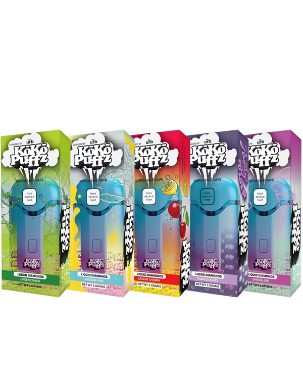 Five boxed disposable vape products in various colorful packaging, labeled "Koko Puffz Liquid Diamonds Disposable Vape." These Delta 8 disposable vape pens from Urb showcase a variety of enticing flavors including "Grape Ape," "Kiwi Kandy," "Cherry Ghost," and two other delightful options.