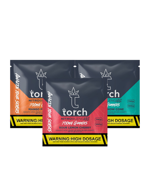 Three packs of Torch Nitro Blend XXL 700mg Gummies | 2ct featuring flavors Mango Peach, Sour Lemon Cherry, and Snow Cone. Each pack includes a warning labeled "High Dosage" at the bottom. These vegan treats are made with premium live resin for an enhanced experience.