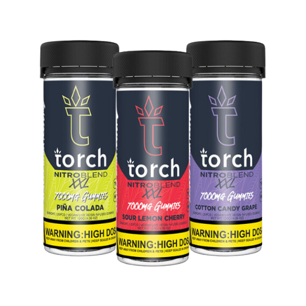 Three cylindrical containers of Torch Nitro Blend XXL Gummies | 7000mg by Torch in pina colada, sour lemon cherry, and cotton candy grape flavors. Labels include a yellow warning for high dosage and live resin content.